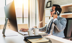 Occ rehab specialist working at desk on phone